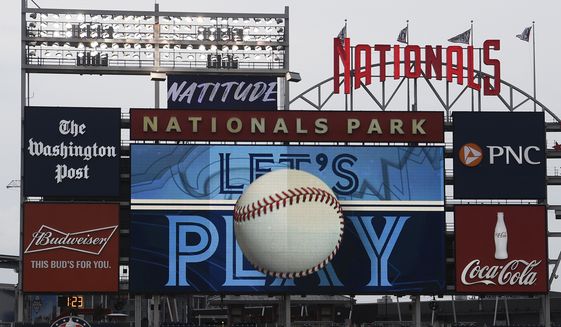 The scoreboard plays the seventh inning stretch themes of the Toronto Blue Jays during the middle of the seventh inning of a baseball game between the Blue Jays and the Washington Nationals, on July 30, 2020, in Washington. Players voted Thursday, March 10, 2022, to accept MLB&#39;s offer on new labor deal, paving way to end 99-day lockout and salvage 162-game season. (AP Photo/Nick Wass, File) **FILE**