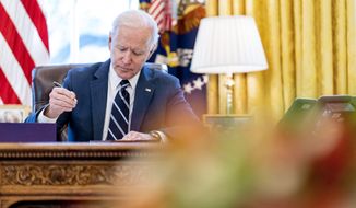 President Joe Biden signs the American Rescue Plan, a coronavirus relief package, in the Oval Office of the White House, March 11, 2021, in Washington. It&#39;s been one year since President Joe Biden signed the American Rescue Plan, a $1.9 trillion package of relief measures intended to fight the coronavirus pandemic and help the economy rebound. Although it was heralded as an early success for Biden, the impact of the legislation remains controversial. (AP Photo/Andrew Harnik, File)