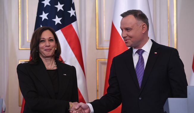 Polish President Andrzej Duda, right, shakes hands with US Vice President Kamala Harris on the occasion of their meeting at Belwelder Palace, in Warsaw, Poland, Thursday, March 10, 2022. (Saul Loeb/Pool Photo via AP)