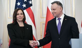 Polish President Andrzej Duda, right, shakes hands with US Vice President Kamala Harris on the occasion of their meeting at Belwelder Palace, in Warsaw, Poland, Thursday, March 10, 2022. (Saul Loeb/Pool Photo via AP)