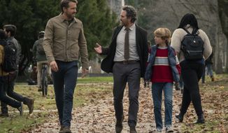 This image released by Netflix shows Ryan Reynolds, from left, Mark Ruffalo and Walker Scobel in a scene from &amp;quot;The Adam Project.&amp;quot; (Doane Gregory/Netflix via AP)