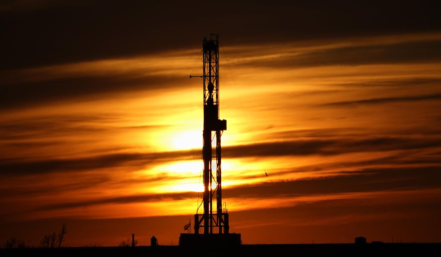 An oil drilling rig is pictured at sunset, March 7, 2022, in El Reno, Okla. The Biden administration has considerably slowed its approval of new oil and natural gas drilling leases on public lands, despite facing pressure to more aggressively urge fossil fuel companies to increase their production in the face of high domestic energy prices. (AP Photo/Sue Ogrocki, File)