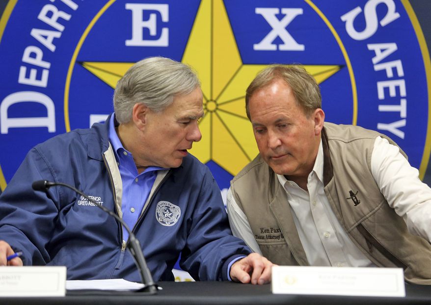 Texas Gov. Greg Abbott, left, and Texas Attorney General Ken Paxton confer during a conference after an Operation Lone Star roundtable discussion at the Texas Department of Public Safety Weslaco Regional Office on Thursday, March 10, 2022, in Weslaco, Texas. (Joel Martinez/The Monitor via AP) ** FILE **