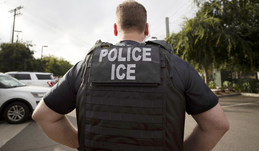 A U.S. Immigration and Customs Enforcement (ICE) officer looks on during an operation in Escondido, Calif., July 8, 2019. Immigration enforcement arrests in the interior of the U.S. fell over the past year as the Biden administration shifted its enforcement focus to people in the country without legal status who have committed serious crimes.  (AP Photo/Gregory Bull, File)