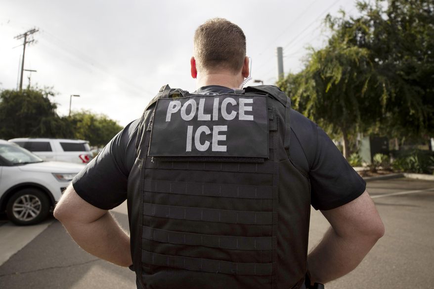 A U.S. Immigration and Customs Enforcement (ICE) officer looks on during an operation in Escondido, Calif.,  July 8, 2019.  Immigration enforcement arrests in the interior of the U.S. fell over the past year as the Biden administration shifted its enforcement focus to people in the country without legal status who have committed serious crimes.  (AP Photo/Gregory Bull, File)