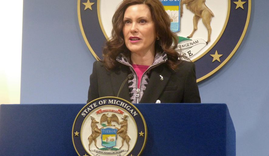 Mich. Gov. Gretchen Whitmer speaks at a news conference on Friday, March 11, 2022, at the governor&#x27;s office in Lansing, Mich. Gov.  Whitmer signed legislation to let the Michigan Parole Board wait five years to review parole for certain inmates. (AP Photo/David Eggert)