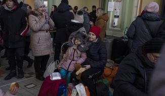 Ukrainian refugees wait at Przemysl train station, southeastern Poland, on Friday, March 11, 2022. Thousands of people have been killed and more than 2.3 million have fled the country since Russian troops crossed into Ukraine on Feb. 24. (AP Photo/Petros Giannakouris)