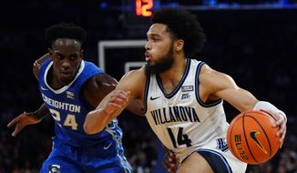 Villanova&#39;s Caleb Daniels (14) drives past Creighton&#39;s Arthur Kaluma (24) during the first half of an NCAA college basketball game in the final of the Big East conference tournament Saturday, March 12, 2022, in New York. (AP Photo/Frank Franklin II)