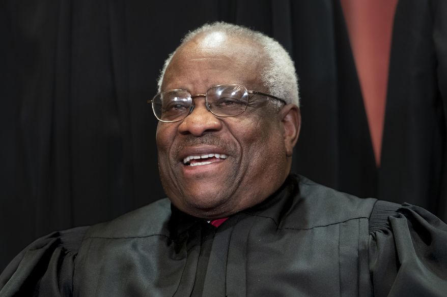 In this Nov. 30, 2018, photo, Supreme Court Associate Justice Clarence Thomas sits for a group portrait at the Supreme Court Building in Washington. (AP Photo/J. Scott Applewhite, File)