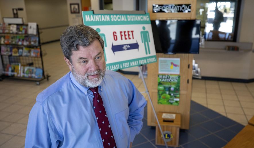In this file photo, signs and temperature stations remain in the lobby at the Kershaw County Government Offices where Kershaw County Administrator Vic Carpenter discusses how the county is getting back to normal Tuesday, March 1, 2022 in Camden, S.C. (Grace Beahm Alford/The Post And Courier via AP)