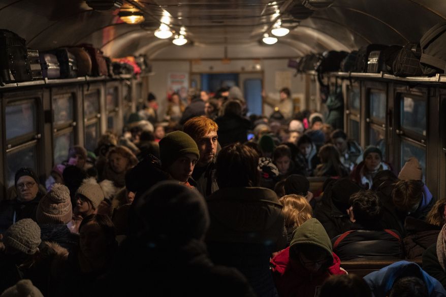 Displaced Ukrainians onboard a Poland-bound train in Lviv, western Ukraine, Sunday, March 13, 2022. (AP Photo/Bernat Armangue)