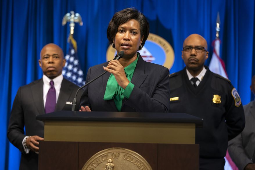 New York Mayor Eric Adams, left, and Washington Metropolitan Police Chief Robert Contee, right, listen as Washington Mayor Muriel Bowser speaks during a news conference about the search for a gunman that has been targeting homeless men sleeping on the streets of Washington, and New York City, Monday, March 14, 2022, in Washington. (AP Photo/Evan Vucci)
