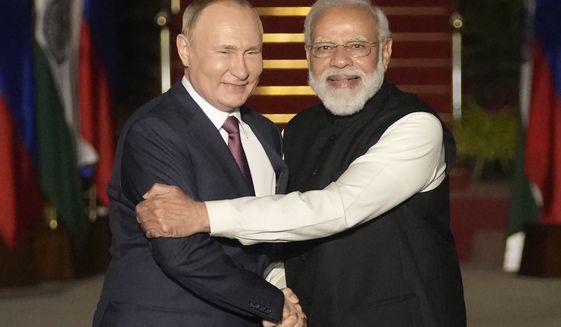 Russian President Vladimir Putin, left, and Indian Prime Minister Narendra Modi greet each other before their meeting in New Delhi, India on Dec. 6, 2021. India is bracing for a disruption in Russian arms supplies following Moscow&#39;s invasion of Ukraine, and Prime Minister Narendra Modi&#39;s tightrope walk between Moscow and Washington could become more difficult due to a border standoff with China. (AP Photo/Manish Swarup, File)