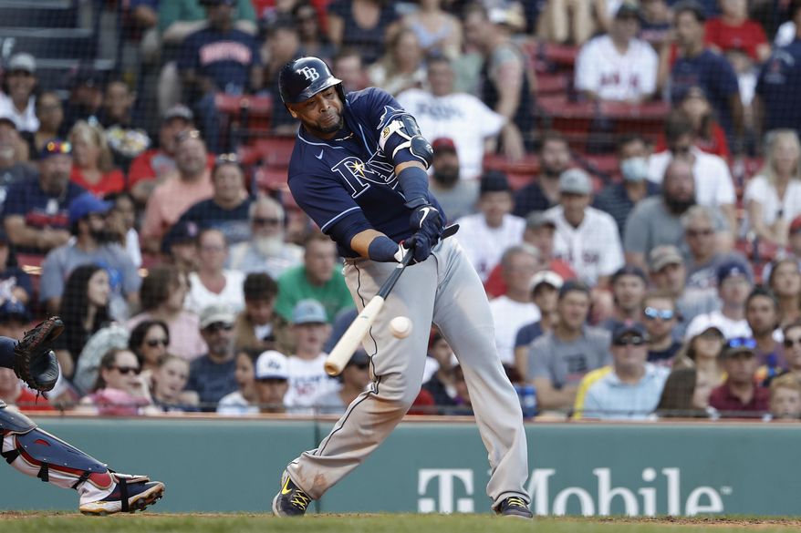Tampa Bay Rays&#39; Nelson Cruz connects on an RBI-double against the Boston Red Sox during the 10th inning of a baseball game Monday, Sept. 6, 2021, at Fenway Park in Boston. A person with direct knowledge of the deal tells The Associated Press that the free agent slugger and the Washington Nationals have agreed to a one-year contract. (AP Photo/Winslow Townson, File)