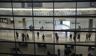 People in the arrivals area at Heathrow Airport in London, Jan. 26, 2021, during England&#39;s coronavirus lockdown. (AP Photo/Matt Dunham, File)