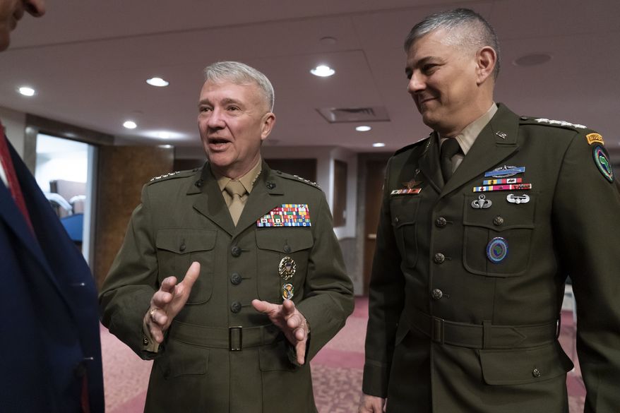 Gen. Kenneth McKenzie, commander of the United States Central Command, left, and Gen. Stephen Townsend, commander of the United States Africa Command, arrive to testify before the Senate Armed Services Committee as the panel holds a hearing on the readiness of the military in Africa and the Middle East, at the Capitol in Washington, Tuesday, March 15, 2022. (AP Photo/J. Scott Applewhite)