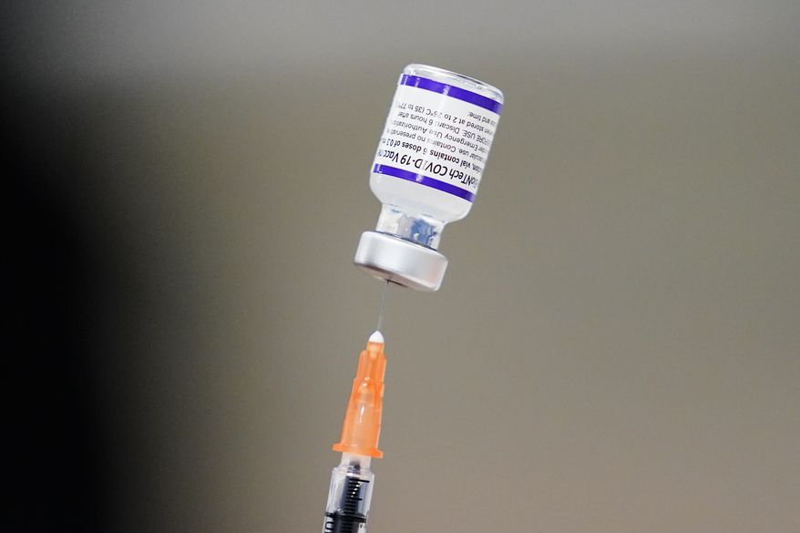 A syringe is prepared with the Pfizer COVID-19 vaccine at a vaccination clinic at the Keystone First Wellness Center in Chester, Pa., on Dec. 15, 2021. Pfizer is expected to request authorization for an additional COVID-19 booster dose for seniors. (AP Photo/Matt Rourke, File)  **FILE**