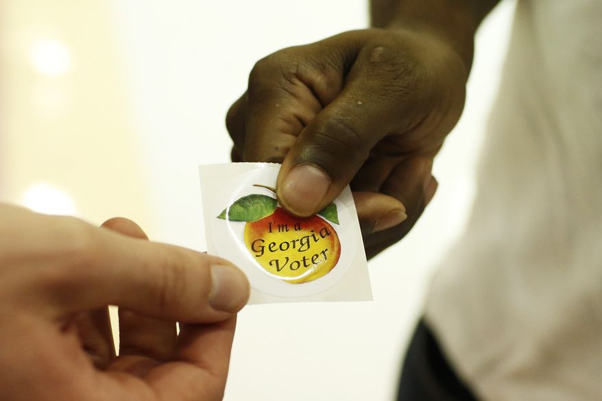 A voters picks up a, &quot;I&#39;m a Georgia Voter,&quot; sticker after voting at Clarke Central High School in Athens, Ga., on Tuesday, Nov. 3, 2020. House Republicans pushed through a bill to make further changes to Georgia&#39;s voting rules late Tuesday, March 15, 2022, over Democratic objections that the GOP was feeding an insatiable monster — Donald Trump&#39;s “big lie” that Georgia&#39;s 2020 election was stolen from the former president, despite no evidence. (Joshua L. Jones/Athens Banner-Herald via AP) **FILE**