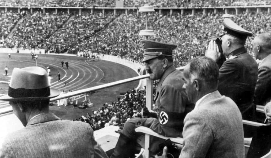 From left to right, Dr. Joseph Goebbels, German Chancellor Adolf Hitler, Reichs Sports Leader Hans von Tschammer und Osten and General Field Marschall Werner von Blomberg observe the Olympic Games in Berlin, Germany in August 1936. The International Olympic Committee has always been political, from the sheikhs and royals in its membership to a seat at the United Nations to pushing for peace talks between the Koreas. But Russia’s invasion of Ukraine three weeks ago exposed its irreconcilable claims of “political neutrality.” (AP Photo, File)