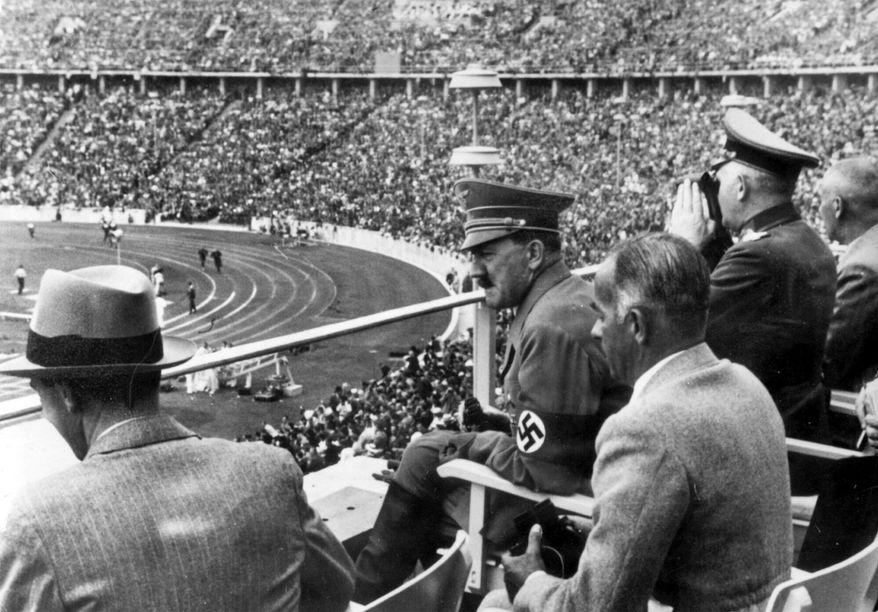From left to right, Dr. Joseph Goebbels, German Chancellor Adolf Hitler, Reichs Sports Leader Hans von Tschammer und Osten and General Field Marschall Werner von Blomberg observe the Olympic Games in Berlin, Germany in August 1936. The International Olympic Committee has always been political, from the sheikhs and royals in its membership to a seat at the United Nations to pushing for peace talks between the Koreas. But Russia’s invasion of Ukraine three weeks ago exposed its irreconcilable claims of “political neutrality.” (AP Photo, File)