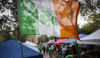 FILE - Revelers prepare for the 195-year-old St. Patrick&#39;s Day parade on one of the city&#39;s historic squares, Saturday, March 16, 2019, in Savannah, Ga.  Savannah is gearing up for a big comeback of its most profitable holiday Thursday, March 17, 2022, as its beloved St. Patrick&#39;s Day parade returns for the first time since 2019.  .(AP Photo/Stephen B. Morton, File)