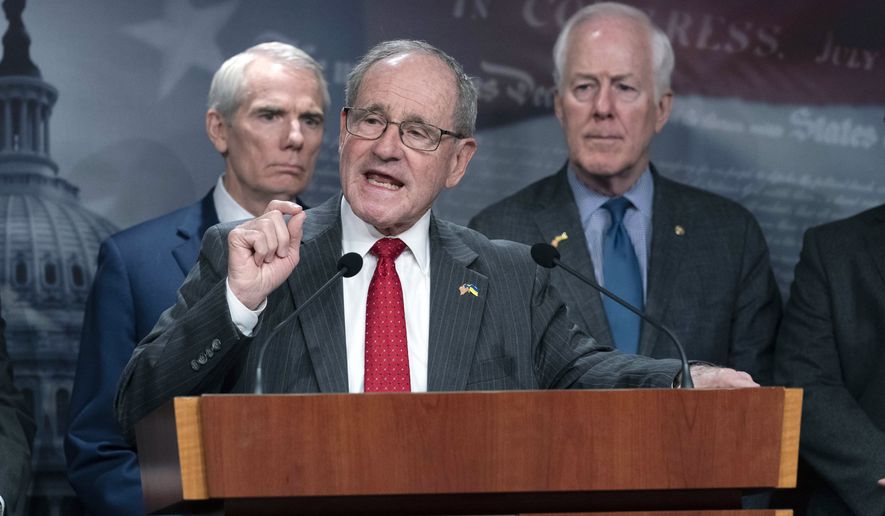 Sen. Jim Risch, R-Idaho, flanked by Sen. Rob Portman, R-Ohio, and John Cornyn, R-Texas, speaks during a news conference about Ukraine on Capitol Hill in Washington, Wednesday, March 16, 2022. After Ukraine President Volodymyr Zelenskyy virtually addressed the U.S. Congress on Wednesday morning. ( AP Photo/Jose Luis Magana)