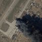 In this satellite picture provided by Planet Labs PBC, fire and smoke is seen at Kherson International Airport and Air Base in Kherson, Ukraine, Tuesday, March 15, 2022. A suspected Ukrainian strike on the air base damaged Russian helicopters and vehicles Tuesday. (Planet Labs PBC via AP)