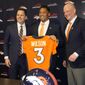 Denver Broncos new starting quarterback Russell Wilson, center, holds up his new jersey for a photograph with head coach Nathaniel Hackett, right, and general manager George Paton during a news conference Wednesday, March 16, 2022, at the team&#39;s headquarters in Englewood, Colo. (AP Photo/David Zalubowski)