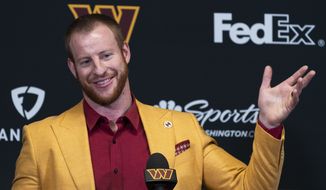 Washington Commanders NFL football team new quarterback Carson Wentz greets members of the media after being introduced by head coach Ron Rivera, a during a news conference in Ashburn, Va., Thursday, March 17, 2022. (AP Photo/Manuel Balce Ceneta)