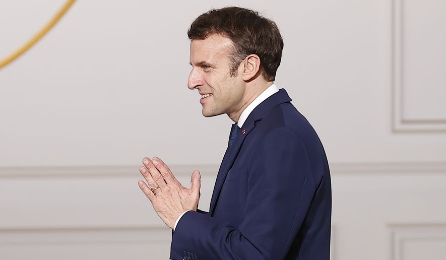 French President Emmanuel Macron arrives to deliver a speech after a medal ceremony for childhood and families, at the Elysee Palace, in Paris, Wednesday, March 16, 2022. (Ian Langsdon, Pool via AP)