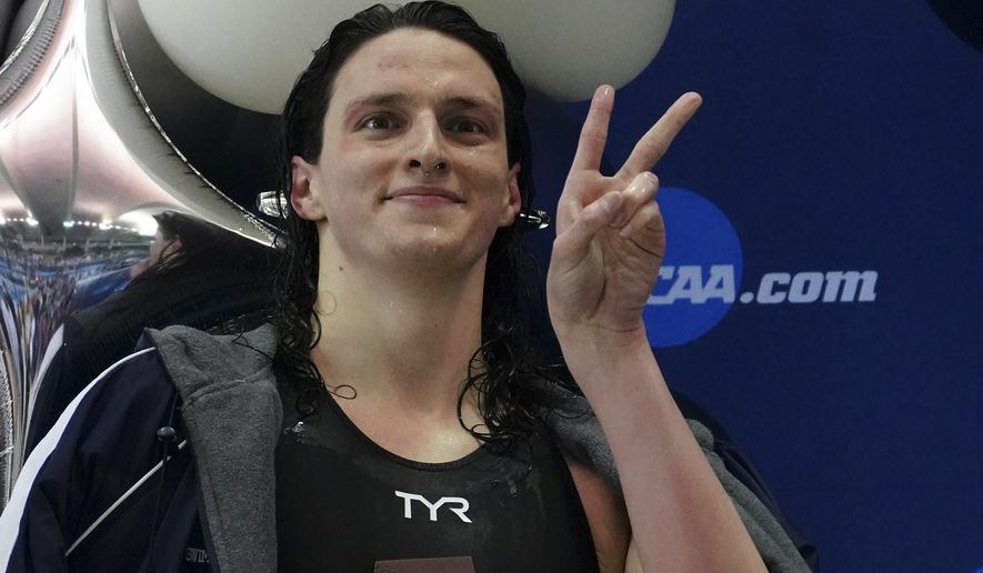 Pennsylvania&#39;s Lia Thomas gestures as she holds the trophy after winning the 500-meter freestyle at the NCAA swimming and diving championships Thursday, March 17, 2022, at Georgia Tech in Atlanta. Thomas is the first known transgender woman to win an NCAA swimming championship. (AP Photo/John Bazemore) **FILE**