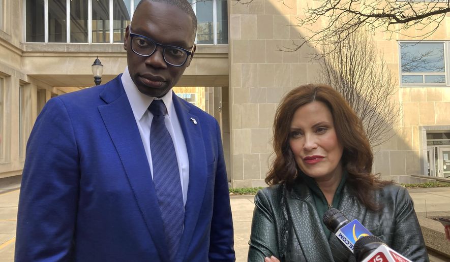First-term Gov. Gretchen Whitmer, a Democrat, right, and Lt. Gov. Garlin Gilchrist II meet with reporters before the pair turned in 30,000 nominating signatures to the state elections bureau to run for reelection on Thursday, March 17, 2022, in Lansing. Mich. (AP Photo/David Eggert)