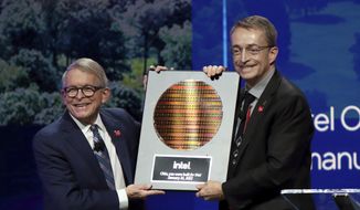 Intel CEO Patrick Gelsinger, right, presents Ohio Gov. Mike DeWine with a silicon wafer on Jan. 21, 2022, in Newark, Ohio, where Intel announced it will invest $20 billion to build two computer chip factories on a 1,000-acre site in Licking County, Ohio, just east of Columbus. (AP Photo/Paul Vernon, File)
