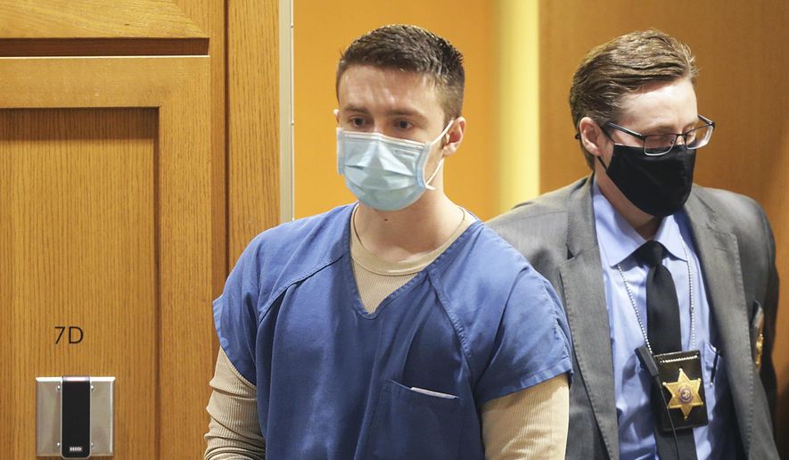 Chandler Halderson is escorted into the Dane County Circuit Court for his sentencing hearing, Thursday, March 17, 2022, in Madison, Wis. Halderson, convicted of killing his parents last summer, was sentenced to life in prison without the possibility of parole. (Kayla Wolf/Wisconsin State Journal via AP)