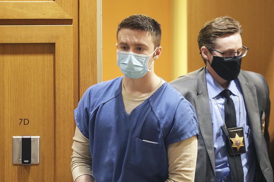 Chandler Halderson is escorted into the Dane County Circuit Court for his sentencing hearing, Thursday, March 17, 2022, in Madison, Wis. Halderson, convicted of killing his parents last summer, was sentenced to life in prison without the possibility of parole. (Kayla Wolf/Wisconsin State Journal via AP)