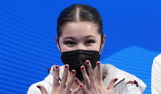 Alysa Liu, of the United States, reacts after competing in the women&#39;s free skate program during the figure skating competition at the Winter Olympics on Feb. 17, 2022, in Beijing. U.S. Olympic figure skater Alysa Liu and her father Arthur Liu — a former political refugee — were among those targeted in a spying operation that the Justice Department alleges was ordered by the Chinese government, the elder Liu said late Wednesday, March 16. (AP Photo/David J. Phillip, File)