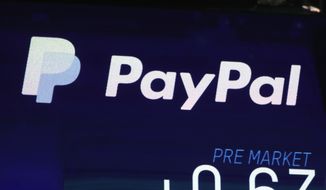In this Oct. 3, 2018, file photo the PayPal logo appears on a screen at the Nasdaq MarketSite, in New York&#x27;s Times Square.   PayPal says that its users will now be able to send money to Ukrainians, both in the war-ravaged country as well as those who are now refugees across Europe, Thursday, March 17, 2022.  (AP Photo/Richard Drew, File)