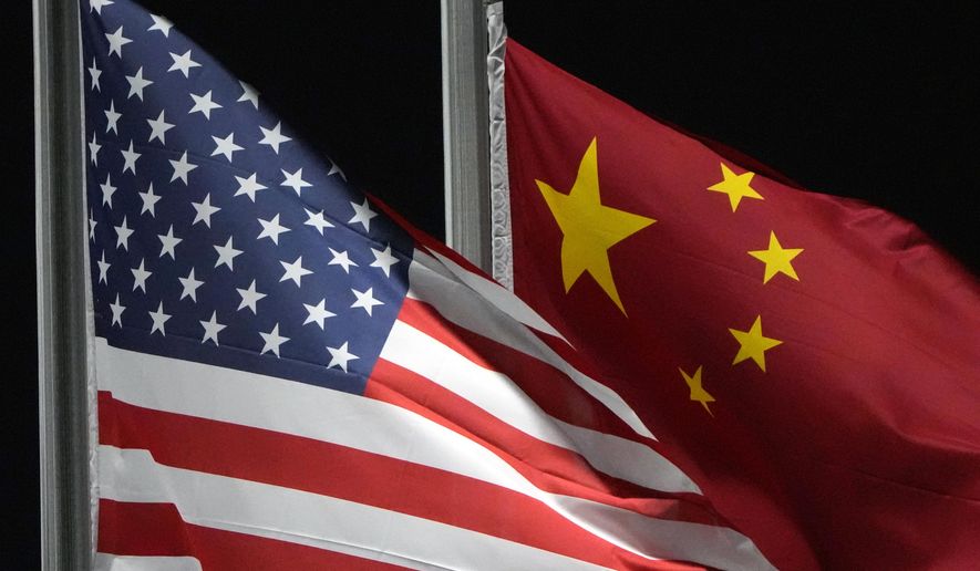 The American and Chinese flags wave at Genting Snow Park ahead of the 2022 Winter Olympics in Zhangjiakou, China, on Feb. 2, 2022. (AP Photo/Kiichiro Sato) **FILE**