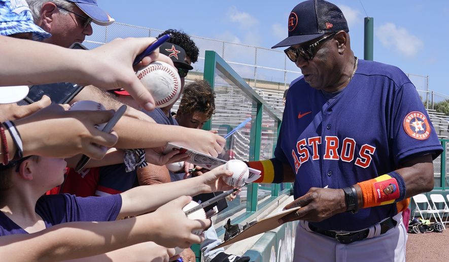 Houston Astros manager Dusty Baker signs autographs for fans before a spring training baseball game against the St. Louis Cardinals, Friday, March 18, 2022, in Jupiter, Fla. (AP Photo/Sue Ogrocki)