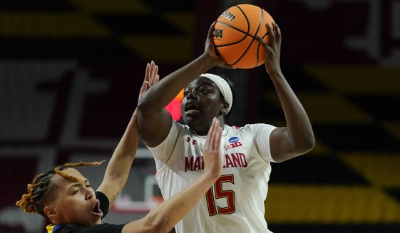 Maryland guard Ashley Owusu (15) drives against Delaware guard Paris McBride during the second half of a college basketball game in the first round of the NCAA tournament, Friday, March 18, 2022, in College Park, Md. Maryland won 102-71. (AP Photo/Julio Cortez)