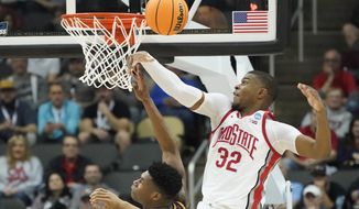 Ohio State&#39;s E.J. Liddell (32) blocks a shot by Loyola Chicago&#39;s Chris Knight during the first half of a college basketball game in the first round of the NCAA tournament, Friday, March 18, 2022, in Pittsburgh. (AP Photo/Keith Srakocic)