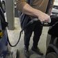 A customer pumps gasoline into his car at a Sam&#39;s Club fuel island in Gulfport, Miss., Feb. 19, 2022, in this file photo. (AP Photo/Rogelio V. Solis, File)  **FILE**