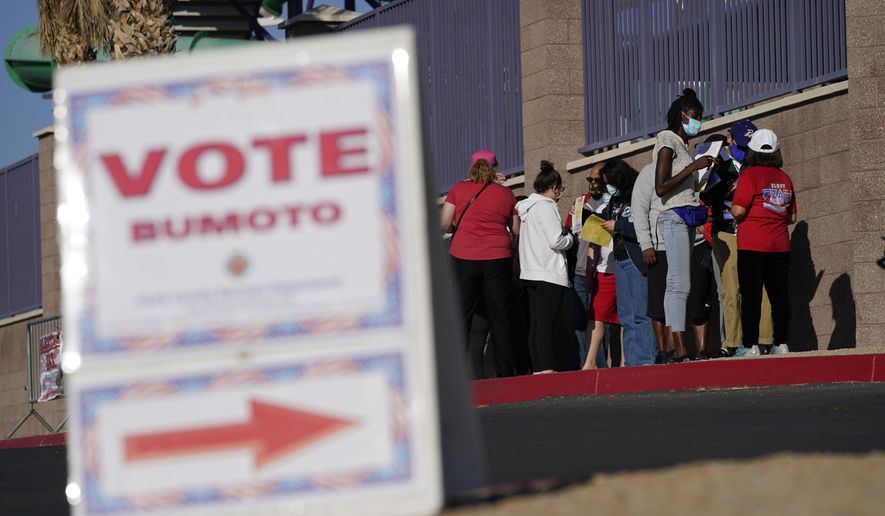 In this Nov. 3, 2020, file photo, people wait in line to vote at a polling place on Election Day in Las Vegas. A new poll shows abortion is not a top concern in the 2022 midterms. (AP Photo/John Locher, File)  **FILE**