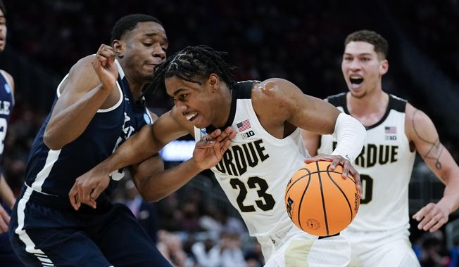 Purdue&#x27;s Jaden Ivey drives past Yale&#x27;s Matthue Cotton during the second half of a first round NCAA college basketball tournament game Friday, March 18, 2022, in Milwaukee. (AP Photo/Morry Gash)