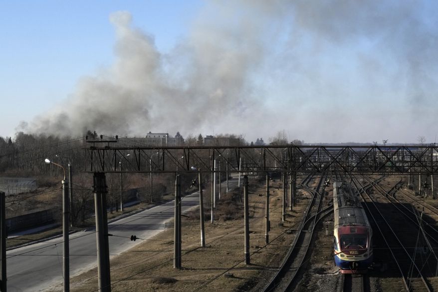 A cloud of smoke raises after an explosion in Lviv, Western Ukraine, Friday, March 18, 2022. The mayor of Lviv says missiles struck near the city&#39;s airport early Friday. (AP Photo/Bernat Armangue)