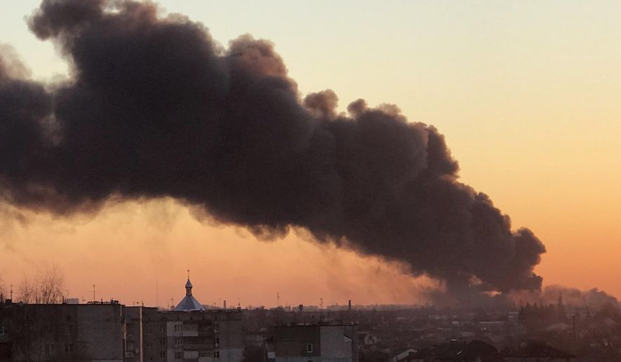 A cloud of smoke raises after an explosion in Lviv, western Ukraine, Friday, March 18, 2022. The mayor of Lviv says missiles struck near the city&#39;s airport early Friday. (AP Photo)