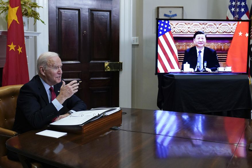 President Joe Biden meets virtually with Chinese President Xi Jinping from the Roosevelt Room of the White House in Washington, on Nov. 15, 2021. (AP Photo/Susan Walsh, File)