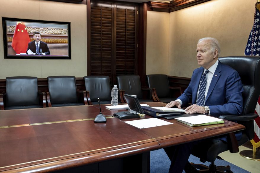 In this image provided by the White House, President Joe Biden meets virtually from the Situation Room at the White House with China’s Xi Jinping, Friday, March 18, 2022, in Washington. (The White House via AP) **FILE**