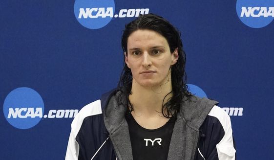 University of Pennsylvania transgender athlete Lia Thomas holds her trophy after finishing tied for fifth the 200 freestyle finals at the NCAA Swimming and Diving Championships Friday, March 18, 2022, at Georgia Tech in Atlanta. Thomas finished tied for fifth place. (AP Photo/John Bazemore)