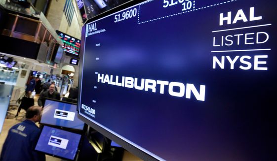 The logo for Halliburton appears above a trading post on the floor of the New York Stock Exchange, Monday, April 23, 2018. U.S. oil field services companies Halliburton Co. and Schlumberger are suspending their operations in Russia as the Houston, Texas-based businesses react to U.S. sanctions over Russia’s invasion of Ukraine. (AP Photo/Richard Drew) **FILE**